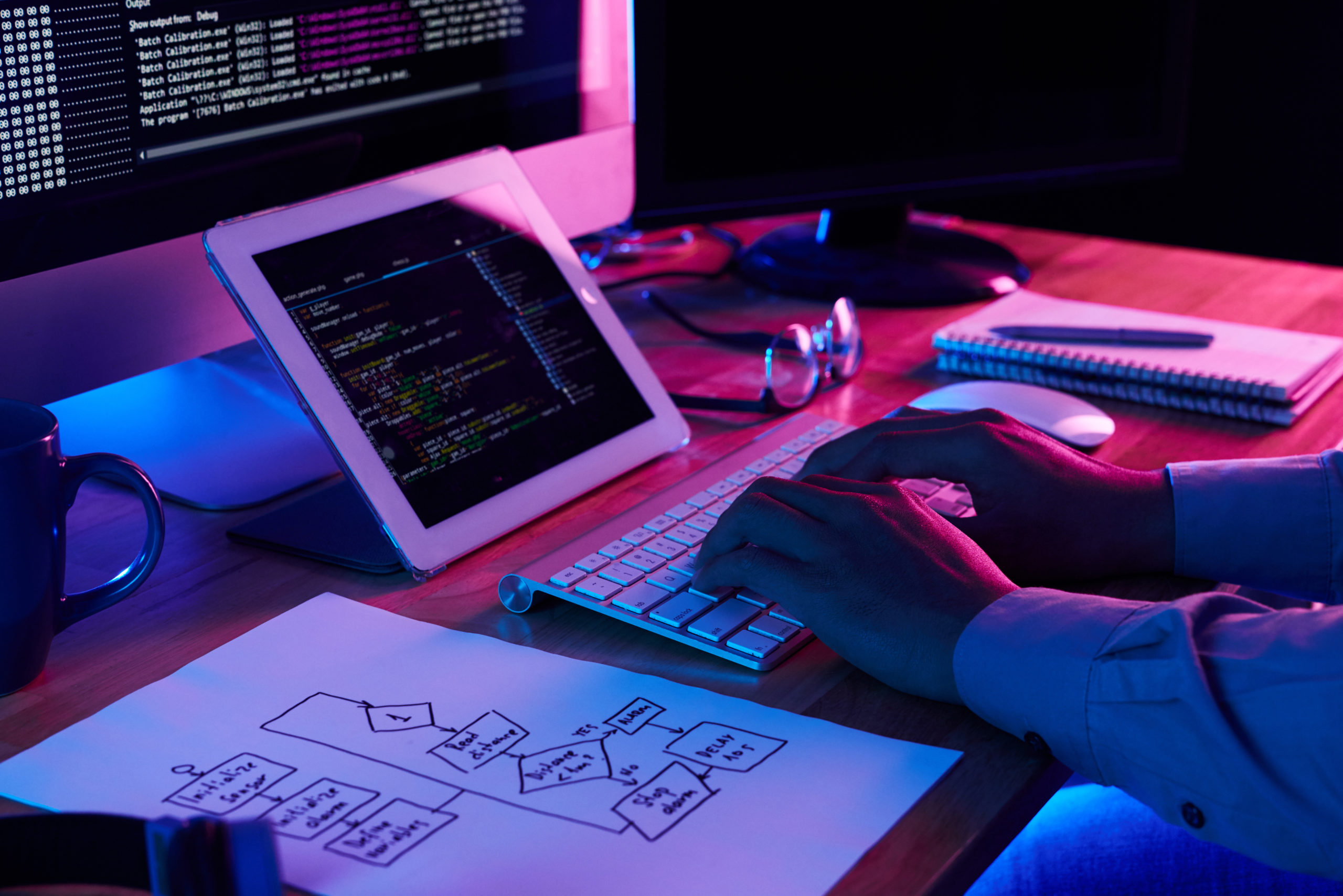close up image of programer working at his desk in office 1 close up image of programer working at his desk in office 1